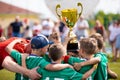 Young Soccer Players Holding Trophy. Boys Celebrating Soccer Football Championship Royalty Free Stock Photo