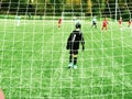 Young soccer team on playground viewed through net Royalty Free Stock Photo