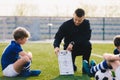 Young Soccer Trainer Coach Explaining Tactic on Team Sports Tactics Board