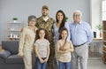 Portrait of happy young soldier and his family standing in the living-room together Royalty Free Stock Photo