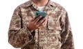 Young soldier holding a mobile phone standing on white background Royalty Free Stock Photo