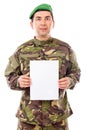 Young soldier holding white sheet of paper Royalty Free Stock Photo