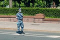 Young soldier of Russia Guard wearing summer camouflage, protective mask and gloves