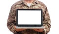 Young soldier showing a laptop with blank screen on white background Royalty Free Stock Photo