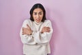 Young south asian woman standing over pink background shaking and freezing for winter cold with sad and shock expression on face Royalty Free Stock Photo