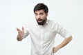 Young spanish man with black beard is actively gesticulating Royalty Free Stock Photo