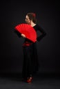 Young spanish woman dancing flamenco on black Royalty Free Stock Photo