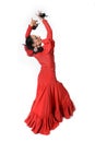 Young Spanish woman dancing flamenco with castanets in her hands