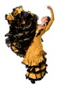 Young Spanish woman dancing flamenco in typical folk tailed gown dress