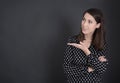 Young spanish woman presenting with hand on blackboard. Royalty Free Stock Photo