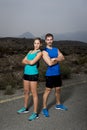 Young sport couple posing shoulder to shoulder looking cool and defiant attitude