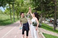 Young sport couple slapping hands in a `high-five` and laughing