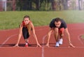 Young sport couple in starting position prepared to compete