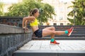 Young sport woman doing exercises during training outside in city park. Fitness model running outdoor Royalty Free Stock Photo