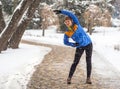 Young sport woman doing exercises during winter training outside in cold snow weather Royalty Free Stock Photo