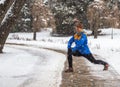 Young sport woman doing exercises during winter training outside in cold snow weather Royalty Free Stock Photo