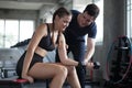 young sport woman exercise lifting dumbbells on the bench in fitness gym healthy .Muscular girl in sportswear training biceps Royalty Free Stock Photo