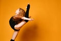 Young sport woman gymnastics doing jumping fitness exercise at sport gym jump on yellow Royalty Free Stock Photo