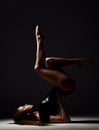 Young sport woman gymnastics doing stretching fitness exercise at dark gym Royalty Free Stock Photo