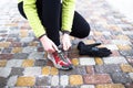 Young sport woman model tying running shoes during Royalty Free Stock Photo