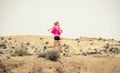 Young sport woman running off road trail dirty road with dry desert landscape background training hard Royalty Free Stock Photo