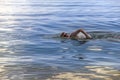 Young sporting man swims in the sea