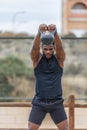 Muscular sportsman doing kettlebell swing exercise in park Royalty Free Stock Photo