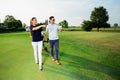 Young sportive couple playing golf on a golf course Royalty Free Stock Photo