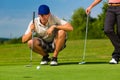 Young sportive couple playing golf on a course Royalty Free Stock Photo