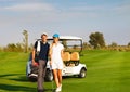 Young sportive couple playing golf on a golf course Royalty Free Stock Photo