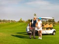 Young sportive couple playing golf on a golf course Royalty Free Stock Photo