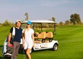 Young sportive couple playing golf on a golf course Royalty Free Stock Photo