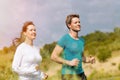 Young sportive couple is running outside Royalty Free Stock Photo