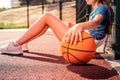 Tired active girl in blue t-shirt sitting on the ground