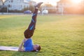 Young sportive man doing exercises in morning field outdoors Royalty Free Stock Photo