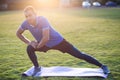 Young sportive man doing stretching exercises before running in morning field outdoors Royalty Free Stock Photo