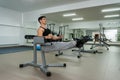 Young and sportive man making stretching exercises in gym Royalty Free Stock Photo