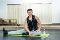 Young and sportive man making stretching exercises in gym Royalty Free Stock Photo