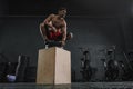 Young sportive man resting after box jump exercise at the gym Royalty Free Stock Photo