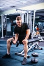 Young sportive man in sportswear lifting some weights Royalty Free Stock Photo