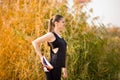 Young sportive woman doing exercises in autumn. Sportswoman stretching her body Royalty Free Stock Photo