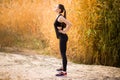 Young sportive woman doing exercises in autumn. Sportswoman stretching her body. Royalty Free Stock Photo