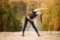 Young sportive woman doing exercises in autumn. Sportswoman stretching her body. Royalty Free Stock Photo