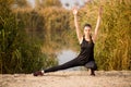 Young sportive woman doing exercises in autumn. Sportswoman stretching her body. Royalty Free Stock Photo