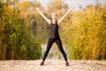 Young sportive woman doing exercises in autumn. Sportswoman stretching her body. Royalty Free Stock Photo