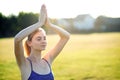 Young sportive woman doing yoga fitness exercises on warm summer day outdoors Royalty Free Stock Photo