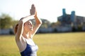 Young sportive woman doing yoga fitness exercises on warm summer day outdoors Royalty Free Stock Photo