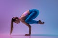 Young sportive woman training isolated on gradient studio background in neon light. athletic and graceful