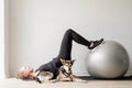 Young sportive woman working out on the fitness ball at home Royalty Free Stock Photo