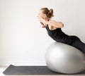 Young sportive woman working out on the fitness ball Royalty Free Stock Photo